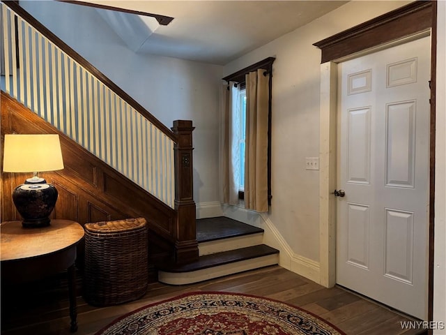 entryway featuring stairway, wood-type flooring, and baseboards