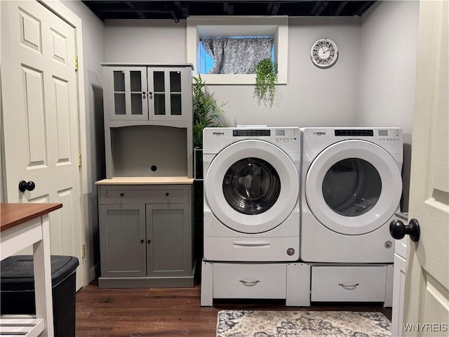 washroom with cabinet space, dark wood-style flooring, and washer and dryer