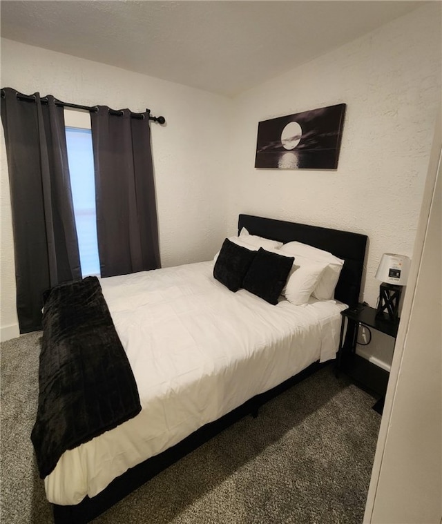 bedroom featuring dark colored carpet