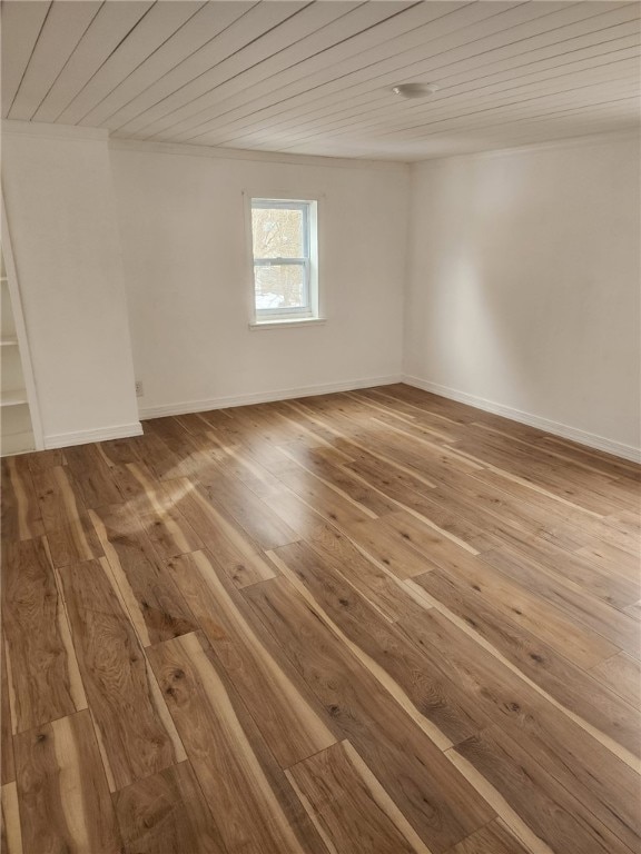 spare room with hardwood / wood-style floors, wood ceiling, and baseboards