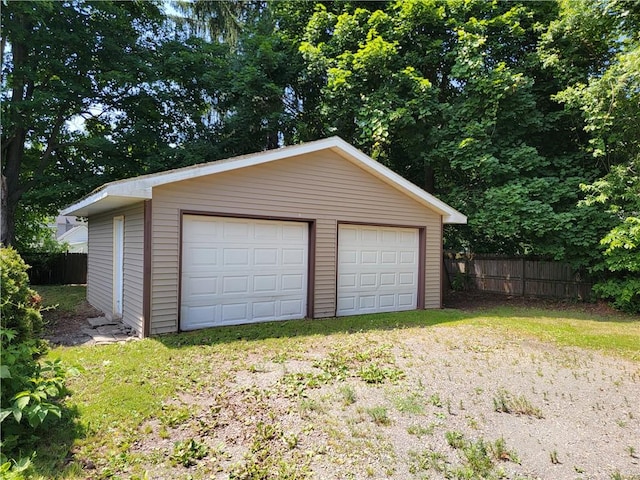 detached garage featuring fence