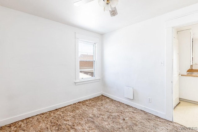 unfurnished room with carpet, ceiling fan, and baseboards