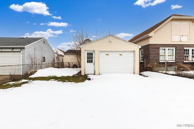 exterior space featuring a detached garage and fence