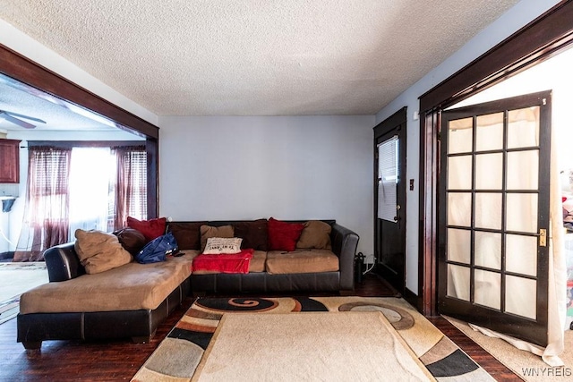 living room with a textured ceiling and wood finished floors