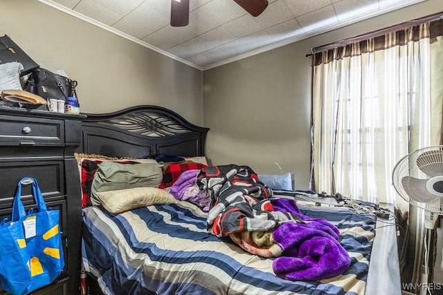 bedroom featuring ornamental molding and ceiling fan