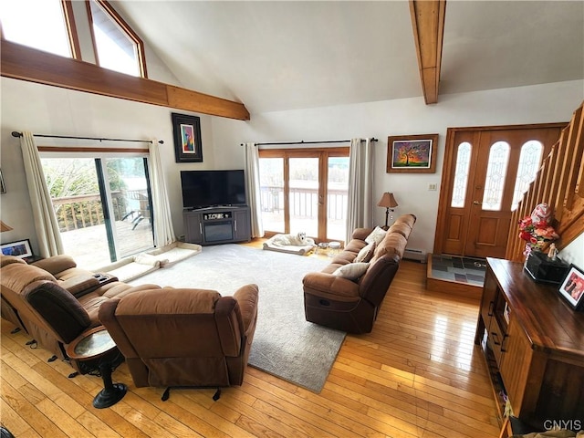 living area with high vaulted ceiling, light wood-type flooring, and beam ceiling