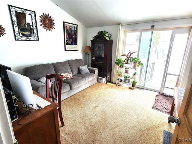 living area featuring vaulted ceiling and carpet flooring