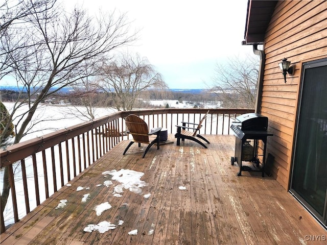 snow covered deck with grilling area