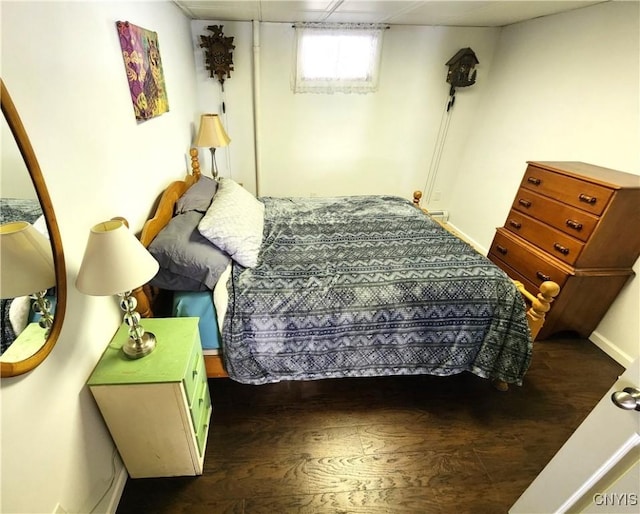 bedroom with baseboards and wood finished floors