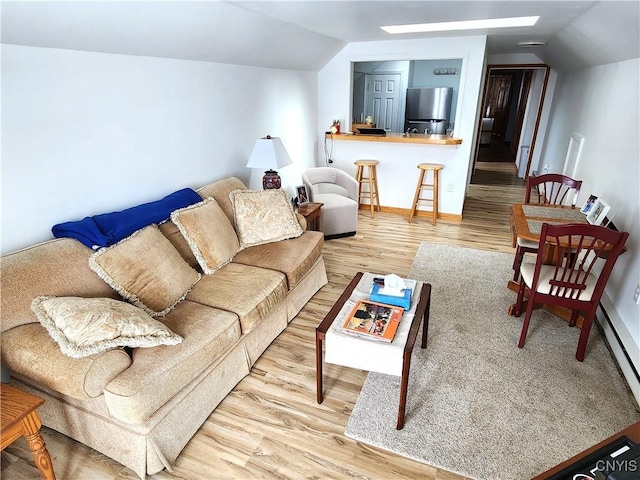 living room featuring vaulted ceiling and wood finished floors