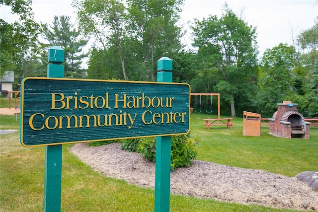 community / neighborhood sign with a lawn