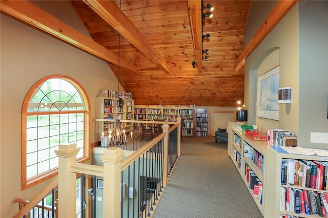 hallway featuring wood ceiling, carpet, lofted ceiling with beams, and an upstairs landing