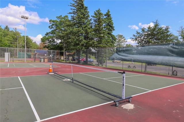 view of tennis court with fence