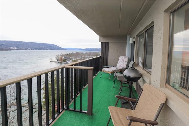 balcony with a water and mountain view