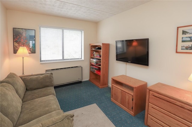 carpeted living area featuring a textured ceiling and radiator