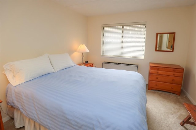 carpeted bedroom featuring radiator and baseboards