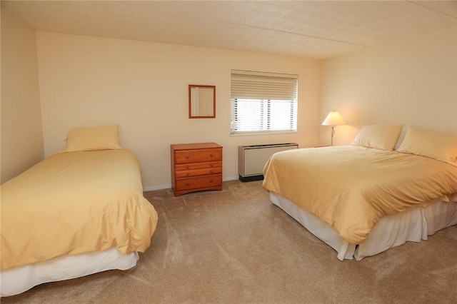 carpeted bedroom featuring radiator