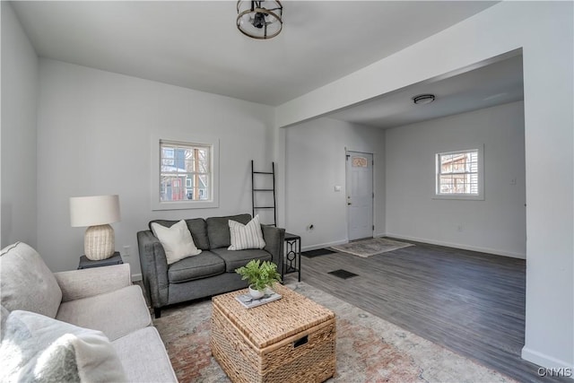 living area featuring wood finished floors and baseboards