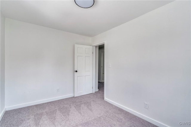 empty room with carpet and baseboards