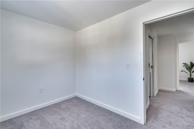 carpeted empty room with baseboards