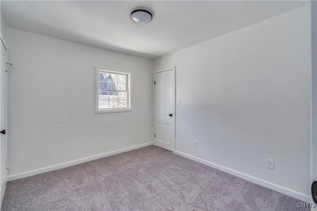 unfurnished bedroom featuring carpet and baseboards