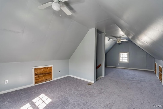 additional living space with baseboards, vaulted ceiling, and carpet flooring