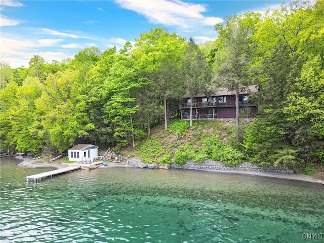 exterior space with a dock and a forest view