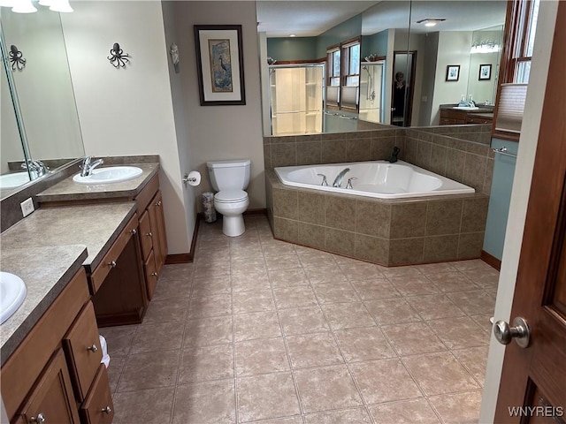 full bath with vanity, a shower stall, toilet, and a bath