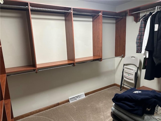 walk in closet with carpet floors and visible vents