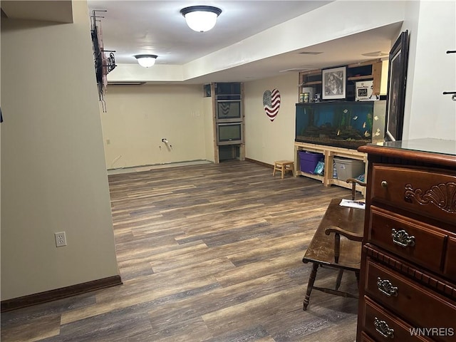 finished basement with baseboards and wood finished floors