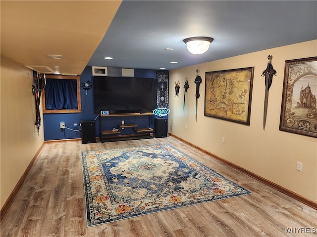 living area with wood finished floors, visible vents, and baseboards