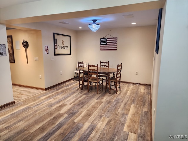 dining space with recessed lighting, light wood-type flooring, and baseboards