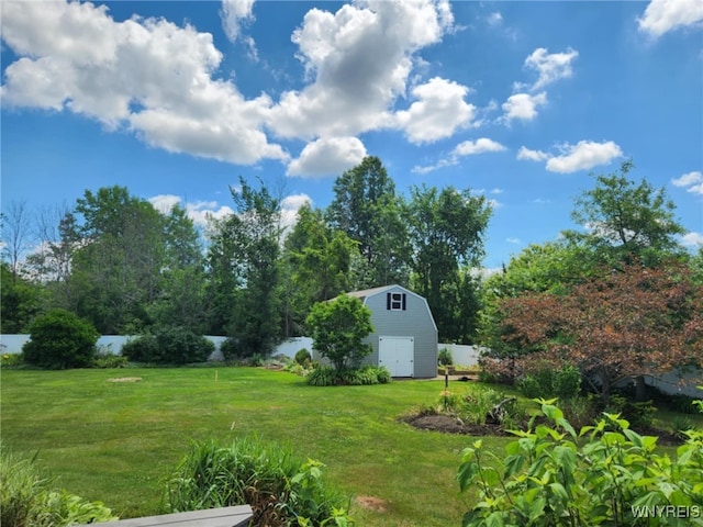 view of yard featuring a storage shed, an outdoor structure, and fence