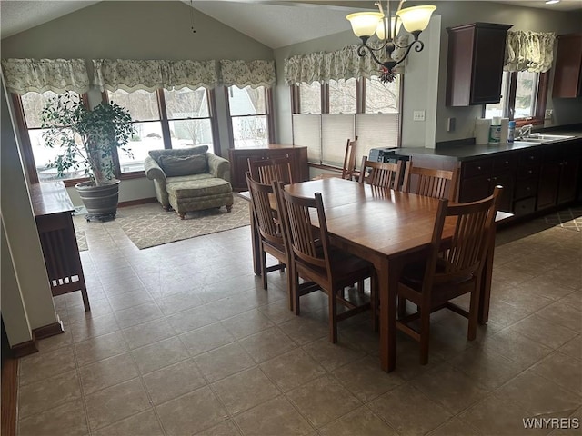 dining space featuring vaulted ceiling and a notable chandelier