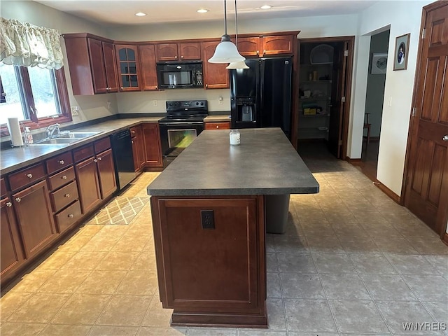 kitchen with dark countertops, glass insert cabinets, a kitchen island, a sink, and black appliances