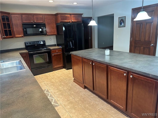 kitchen featuring black appliances, a sink, glass insert cabinets, and pendant lighting