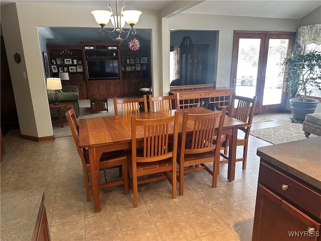 dining room featuring light tile patterned floors and an inviting chandelier