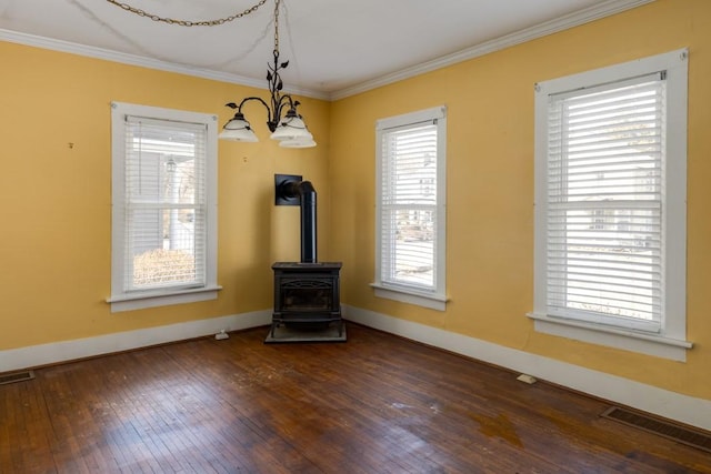 903 W 1st St, Elmira, NY 14905 - unfurnished dining area with dark wood finished floors, crown molding, a chandelier, and a wood stove