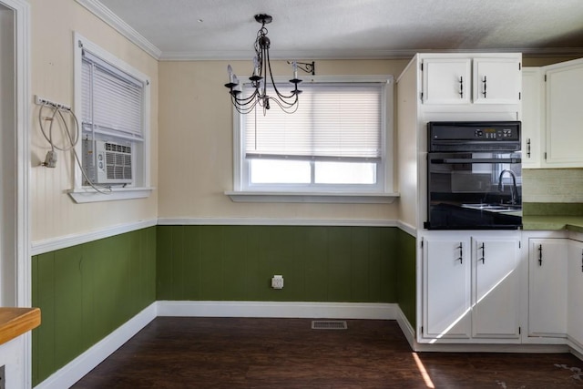 903 W 1st St, Elmira, NY 14905 - kitchen featuring oven, a chandelier, dark wood-style floors, wainscoting, and white cabinets