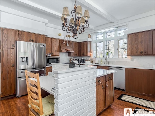 kitchen featuring stainless steel appliances, light countertops, dark wood finished floors, and custom exhaust hood