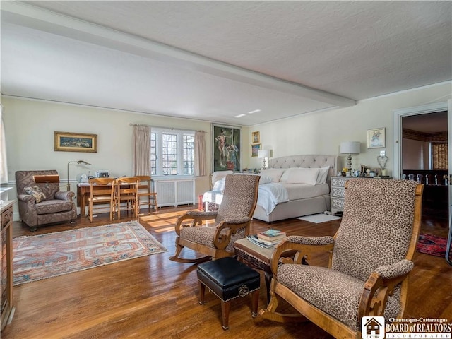 living area featuring a textured ceiling and wood finished floors