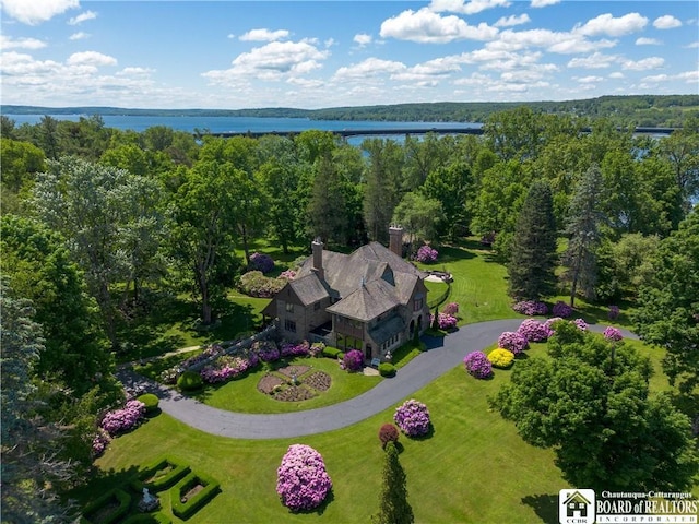 bird's eye view featuring a forest view and a water view