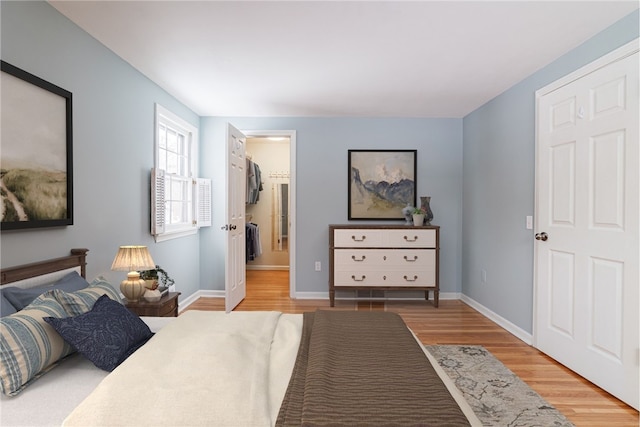 bedroom with baseboards and light wood finished floors