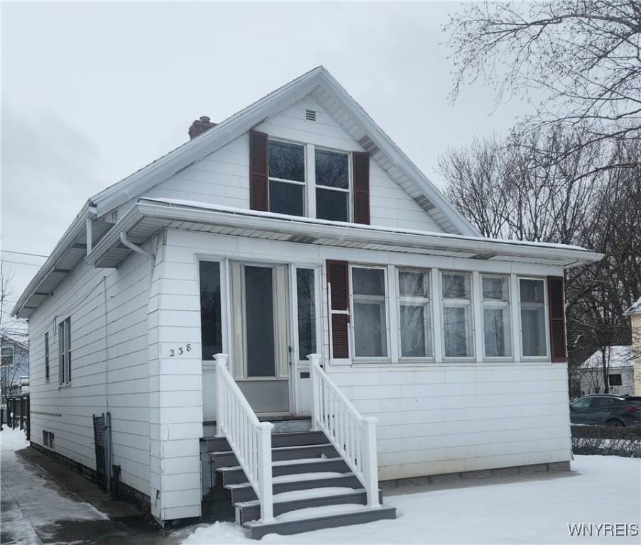 bungalow-style house with a sunroom