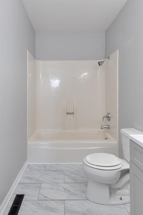 full bathroom with shower / tub combination, toilet, vanity, baseboards, and marble finish floor