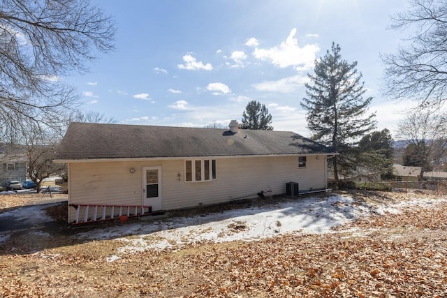 back of property with roof with shingles