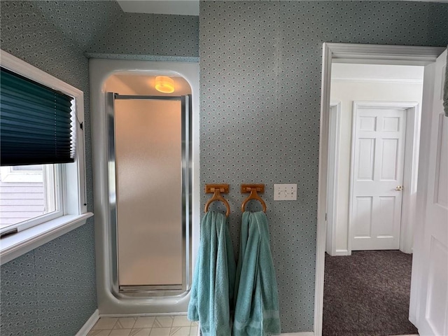 bathroom with baseboards, a shower stall, and wallpapered walls