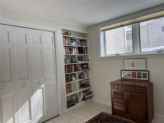 interior space with baseboards and light tile patterned floors