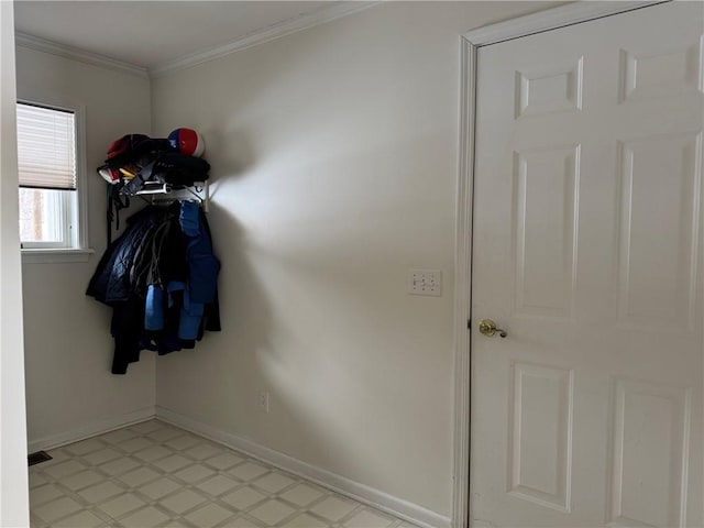 doorway with light floors, visible vents, baseboards, and ornamental molding