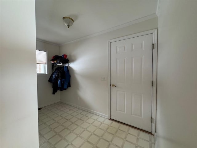 doorway to outside featuring baseboards, light floors, and crown molding